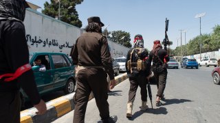 Taliban supporters parade through the streets of Kabul.