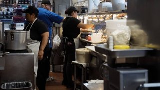 Workers at a restaurant at Grand Central Market in Los Angeles, California, US, on Thursday, Nov. 2, 2023.