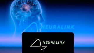 The Neuralink logo is displayed on a smartphone with Neuralink visible in the background in this photo illustration in Brussels, Belgium, on January 30, 2024.