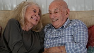 World War II veteran Harold Terens, 100, right, and Jeanne Swerlin, 96, share a laugh as they speak during an interview, Thursday, Feb. 29, 2024, in Boca Raton, Fla. Terens will be honored by France as part of the country's 80th anniversary celebration of D-Day. In addition, the couple will be married on June 8 at a chapel near the beaches where U.S. forces landed. (AP Photo/Wilfredo Lee)