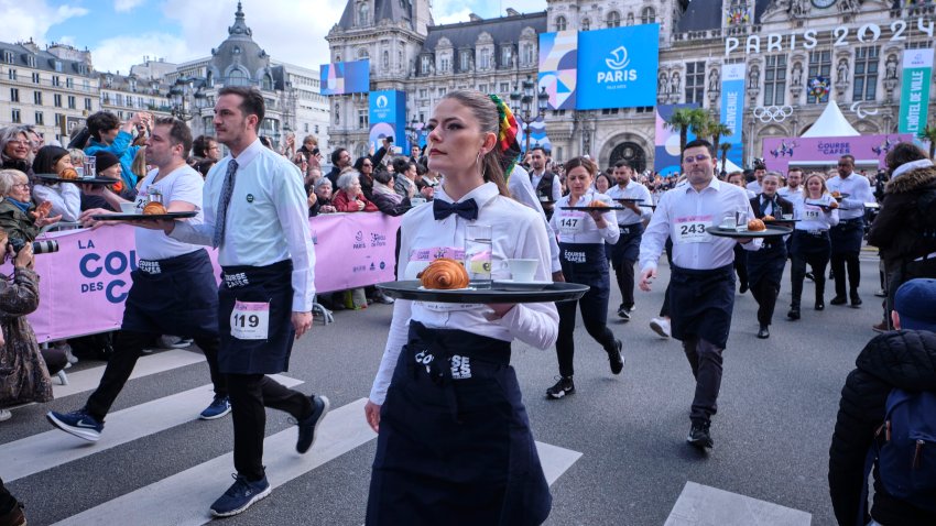 Waiters and waitresses start their fast walk of 2 kilometers with a tray during the Cafe run on March 24, 2024 in Paris, France.