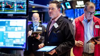 Traders work on the floor of the New York Stock Exchange.