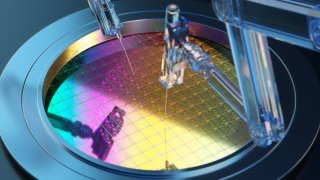 Holographic robot arms making semiconductor.