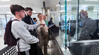 The De Staercke family gets screened by a Custom Border Protection officer in the port of entry at Washington Dulles International Airport in Chantilly, Va. Monday, April 1, 2024.