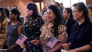 Women representing more than 20 countries take part in a Naturalization Ceremony