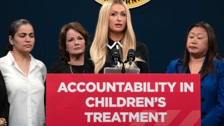 Hotel heiress and media personalty Paris Hilton, center, discusses a proposed bill calling on more transparency for youth treatment facilities