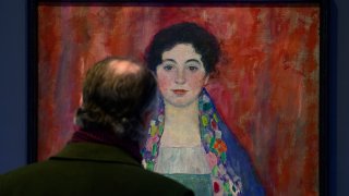 A man looks at the painting 'Portrait of Fräulein Lieser' by Austrian painter Gustav Klimt prior to an auction, in Vienna, April 24, 2024.