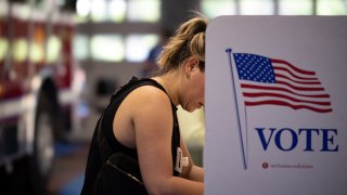 A voter casts her ballot in the Pennsylvania primary elections at the Rockledge Fire Company in Rockledge, Pennsylvania, May 17, 2022.