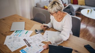 Woman at home looking at the bills and taxes.