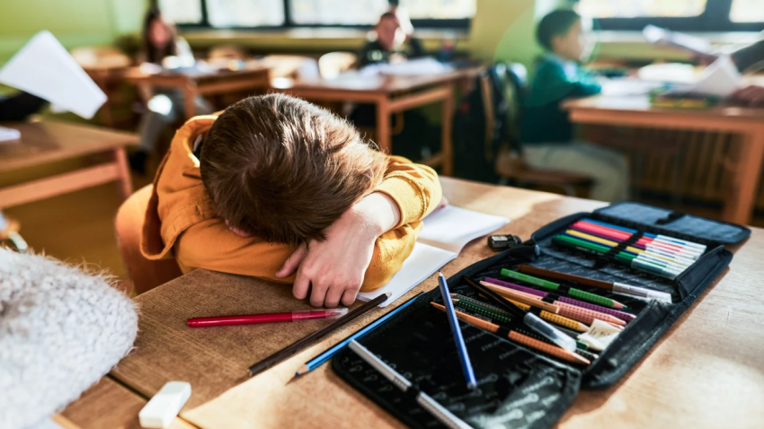 Child in school with his head down