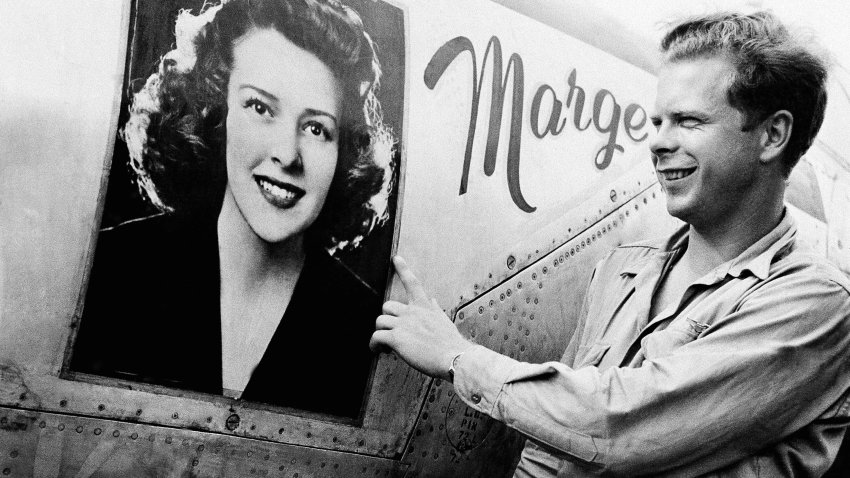 FILE – Captain Richard J. Bong, of Poplar, Wis., points to a large picture of his girl friend, Marge Vattendahl, on his Lighting P-38 fighter plane pilot stationed at a New Guinea Air Base, March 31, 1944. Searchers announced Thursday, May 23, 2024, that they’ve discovered what they believe is the wreckage of World War II ace Bong’s plane in the South Pacific.