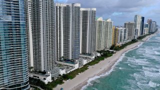 SUNNY ISLES BEACH – FEBRUARY 16: In an aerial view, a strip of beach separates the ocean from condo buildings on February 16, 2022 in Sunny Isles Beach, Florida. A new report released by climate scientists shows that sea levels along coastlines in the United States will rise about one foot by 2050, with larger increases on the East and Gulf coasts. (Photo by Joe Raedle/Getty Images)