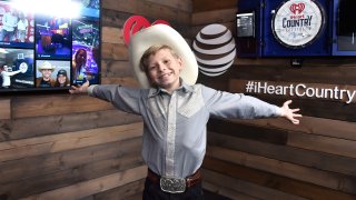Mason Ramsey poses backstage at the 2018 iHeartCountry Festival By AT&T