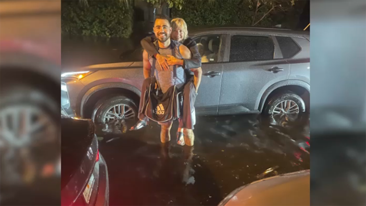 Story behind photo of stranger saving woman stranded in South Florida