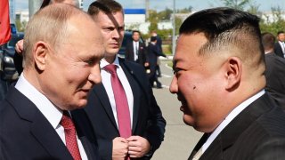 Russia’s President Vladimir Putin (L) shakes hands with North Korea’s leader Kim Jong Un during their meeting at the Vostochny Cosmodrome in Amur region on September 13, 2023. 