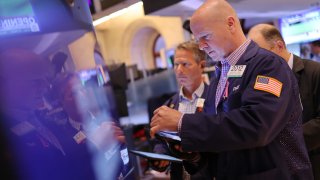 Traders work on the floor of the New York Stock Exchange during morning trading on May 24, 2024.