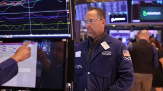 Traders work on the floor of the New York Stock Exchange during morning trading on May 31, 2024.