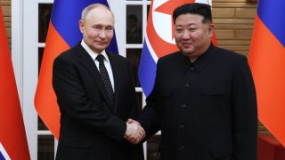In this pool photograph distributed by the Russian state agency Sputnik, North Korea’s leader Kim Jong Un (R) and and Russian President Vladimir Putin shake hands after a welcoming ceremony at Kim Il Sung Square in Pyongyang on June 19, 2024. 