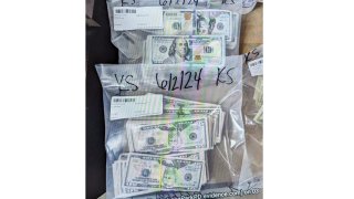 This photo supplied by the U.S. Attorney's Office for Minnesota shows cash from a bag that was left at the home of a juror in a massive fraud case, June 2, 2024