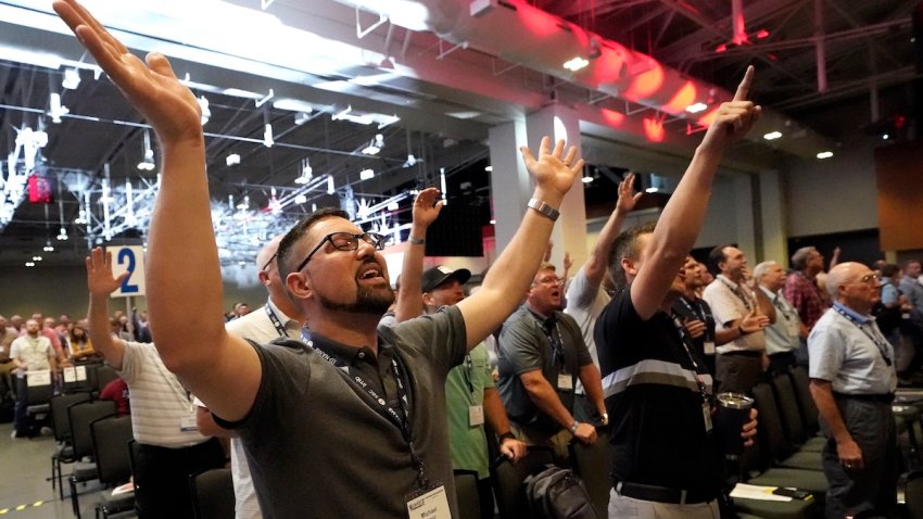 FILE – People take part in a worship service during the annual Southern Baptist Convention meeting Tuesday, June 15, 2021, in Nashville, Tenn. Southern Baptists gathering at their next annual meeting June 11-12, 2024, in Indianapolis will vote on whether to enact a constitutional ban on churches with women pastors.