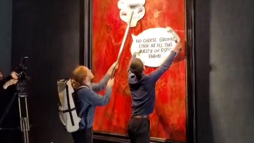 Animal rights activists paste a cartoon image on top of a portrait of King Charles III