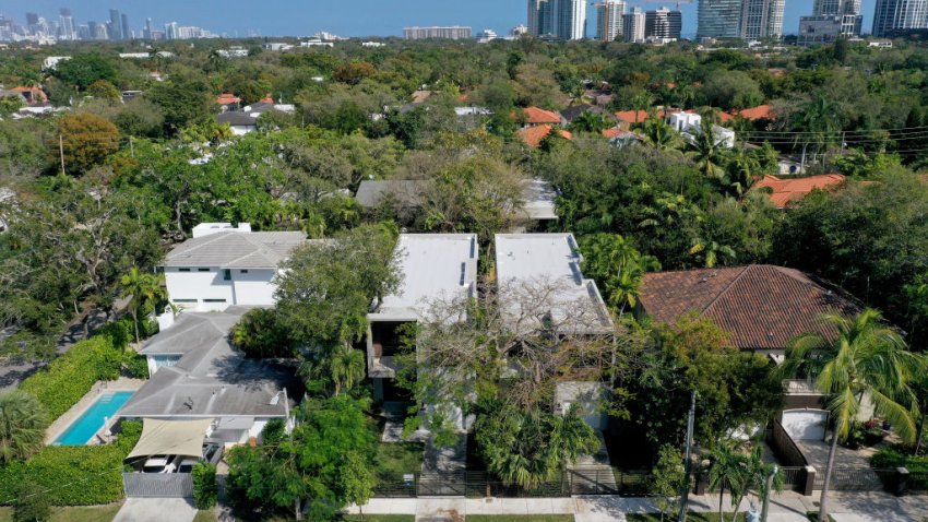 MIAMI, FLORIDA – FEBRUARY 18:  In an aerial view, homes (in the middle) Zillow shows were sold for 2,250,000 dollars in the Coconut Grove neighborhood on February 18, 2022 in Miami, Florida. According to a report released by the RealtyHop real estate website, Miami is now the least affordable housing market in the nation passing New York City. The report showed that residents have to spend 78.71% of their income for homeownership in Miami, slightly overtaking New York City’s 77.98%. (Photo by Joe Raedle/Getty Images)