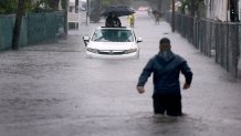 HALLANDALE BEACH, FLORIDA - JUNE 12: A person waits for help in a stalled vehicle sitting in the flooded street on June 12, 2024, in Hallandale Beach, Florida. The region is being adversely impacted as tropical moisture passes through the area. (Photo by Joe Raedle/Getty Images)