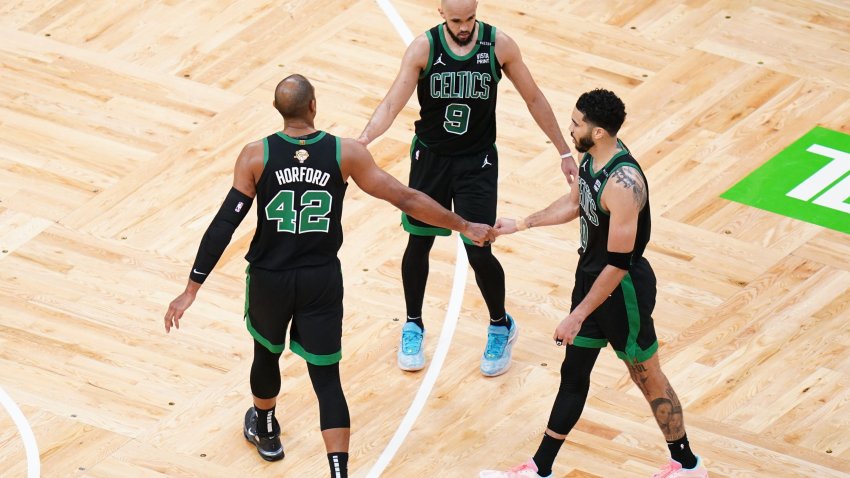 Jun 9, 2024; Boston, Massachusetts, USA; Boston Celtics center Al Horford (42) and guard Derrick White (9) and forward Jayson Tatum (0) celebrate after defeating the Dallas Mavericks in game two of the 2024 NBA Finals at TD Garden. Mandatory Credit: David Butler II-USA TODAY Sports