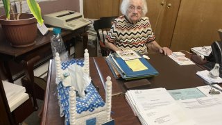 Miriam Todd, 100, at her desk in Nehlig’s Furniture in Stratford, New Jersey, where she still works six days a week.