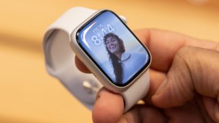 A shopper holds an Apple Watch Series 8 on sale at the company’s Fifth Avenue store in New York, Sept. 16, 2022.