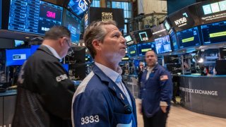 Traders walk the floor during morning trading at the New York Stock Exchange (NYSE) on May 14, 2024 in New York City. 