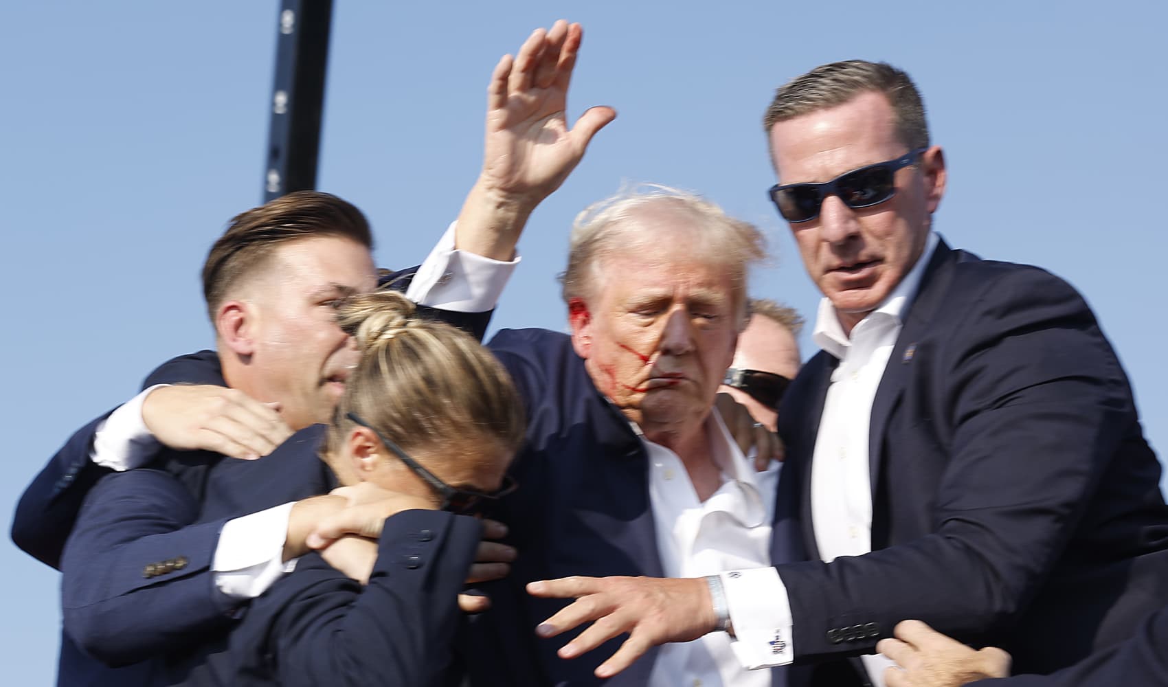 Republican presidential candidate former President Donald Trump is rushed offstage during a rally on July 13, 2024 in Butler, Pennsylvania.