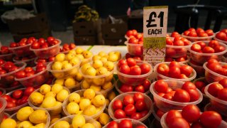 A one pound price label in bowls of produce on a grocery stall at East Street Market in London, UK, in spring 2024.