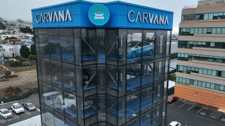 In an aerial view, a sign is posted on the exterior of a Carvana car vending machine on in Daly City, California, on July 19, 2023.