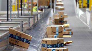 Amazon packages move along a conveyor