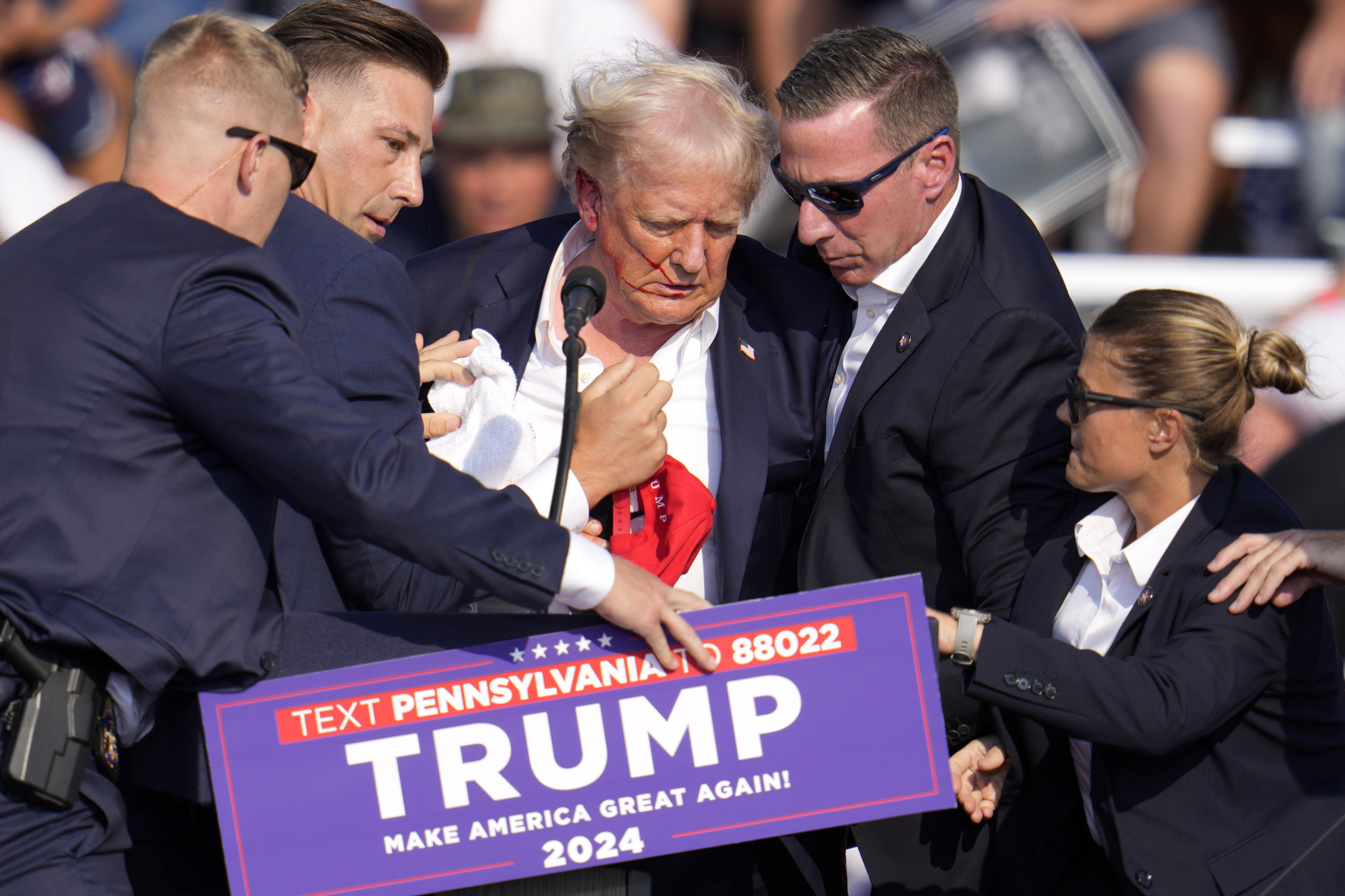 Republican presidential candidate former President Donald Trump is helped off the stage at a campaign event in Butler, Pa., on Saturday, July 13, 2024.