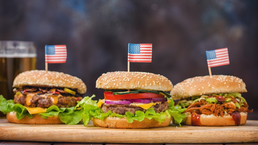 Homemade burgers with American flag toothpicks.