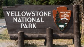 The wooden entrance sign to Yellowstone National Park, USA.