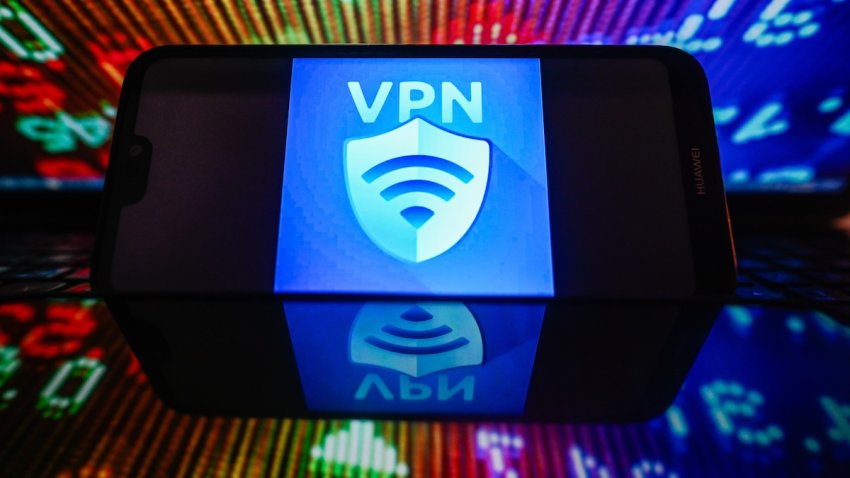 In this photo illustration, VPN logo seen displayed on a smartphone with stock market percentages in the background.