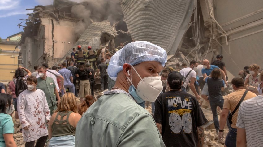 Volunteers, including medics, help emergency and rescue personnel to clear the rubble of a destroyed building at Ohmatdyt Children's Hospital in Kyiv.