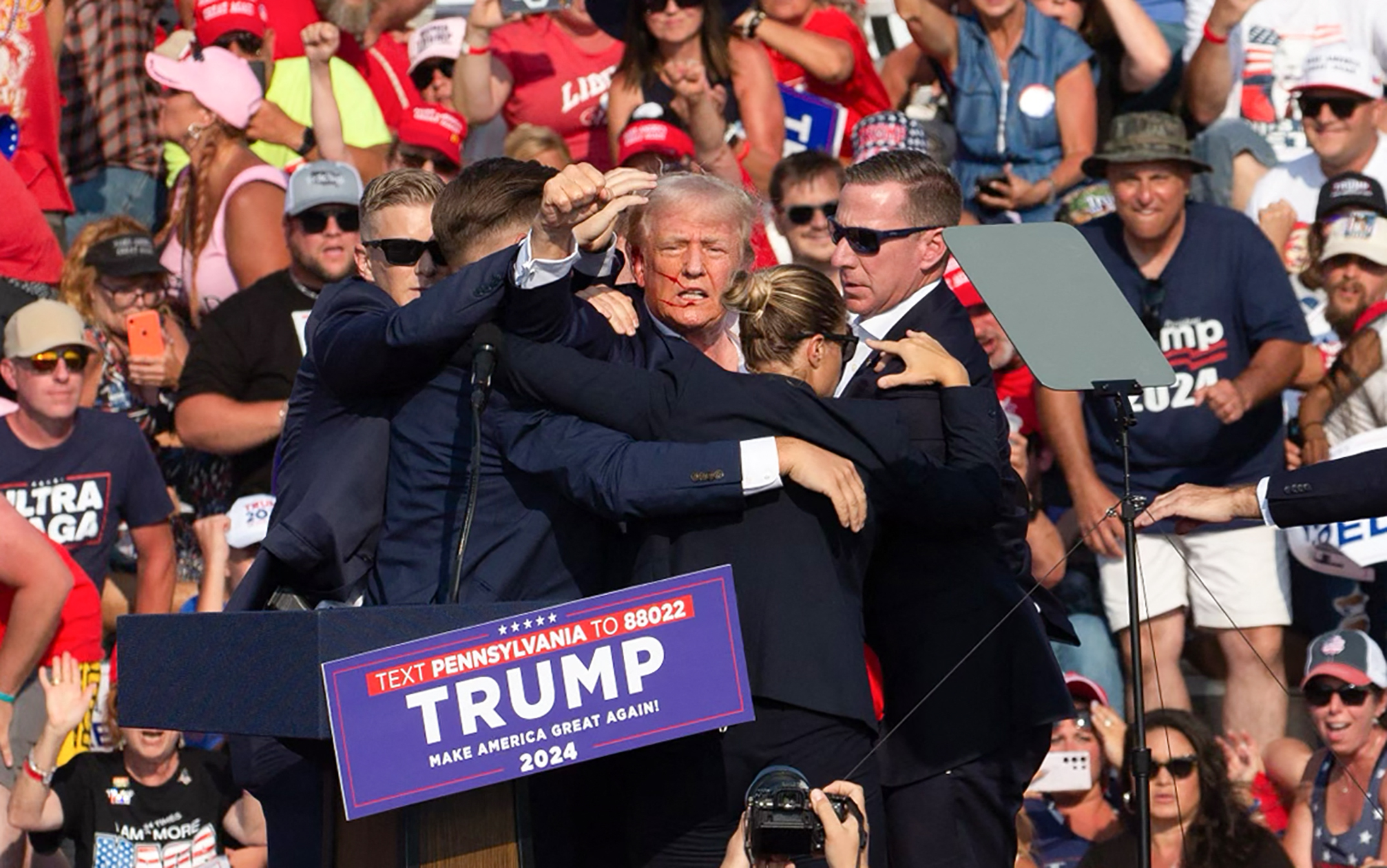 Republican candidate Donald Trump is seen with what appears to be blood on his face surrounded by secret service agents as he is taken off the stage at a campaign event at Butler Farm Show Inc. in Butler, Pennsylvania, July 13, 2024.