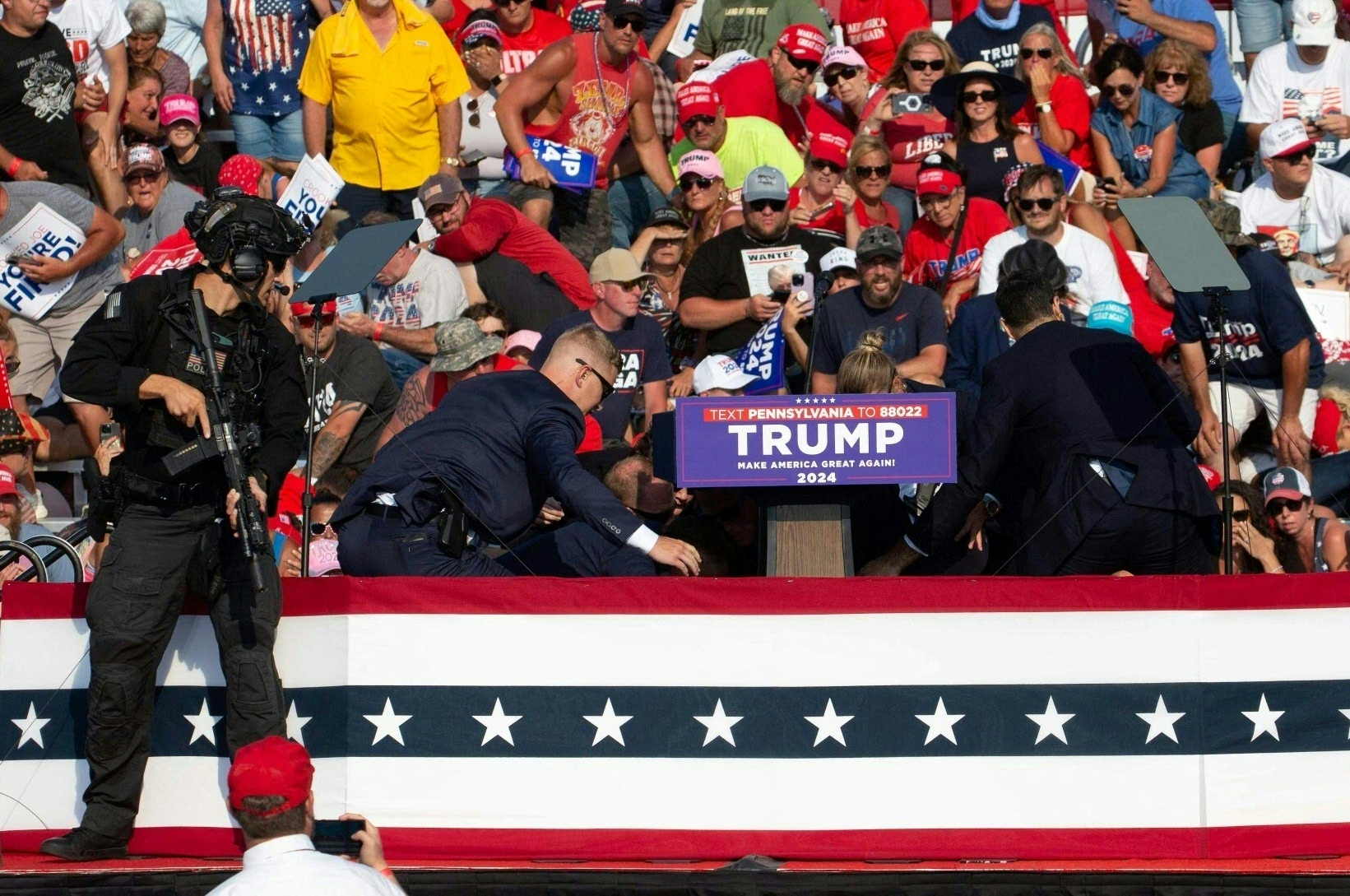 Republican candidate Donald Trump is seen with blood on his face surrounded by secret service agents as he is taken off the stage at a campaign event at Butler Farm Show Inc. in Butler, Pennsylvania, July 13, 2024.