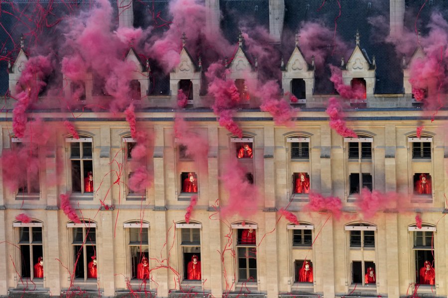 Smoke billows near windows as performers participate