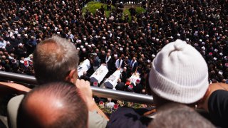 Mourners watch a funeral for people killed in a rocket strike from Lebanon a day earlier, during a funeral in Majdal Shams, in the Israel controlled Golan Heights, on Saturday, July 27, 2024.