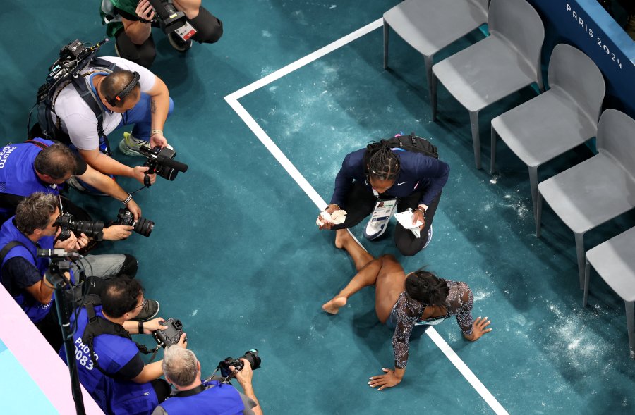 Simone Biles of Team United States receives treatment on the sidelines during the Artistic Gymnastics Women's Qualification