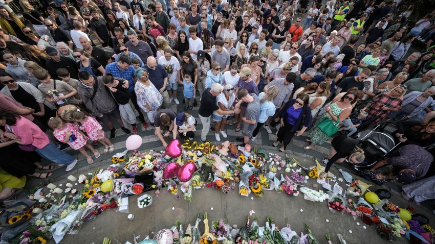 People attend a vigil outside the Atkinson building in central Southport which is being held for the child victims of a knife attack on July 30, 2024 in Southport, England. A teenager armed with a knife attacked children at a Taylor Swift-themed holiday club in Hart Lane, Southport yesterday morning. Three children have died while five children and two adults remain in a critical condition in hospital. A 17-year-old boy has been arrested.