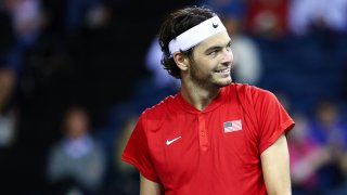 taylor fritz looks off into the distance smiling