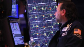 Traders work on the floor of the New York Stock Exchange during afternoon trading on Jan. 22, 2024.