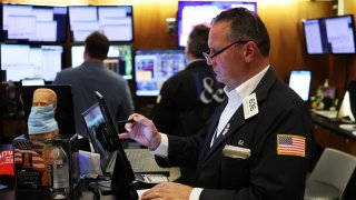 A trader works on the floor of the New York Stock Exchange (NYSE) ahead of the closing bell in New York City on August 5, 2024. 