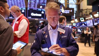 Traders work on the floor of the New York Stock Exchange during morning trading on August 06, 2024 in New York City. 